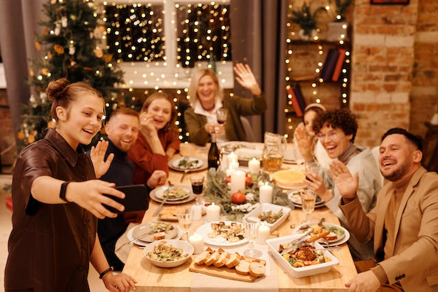 família tira fotografia durante a ceia de Natal